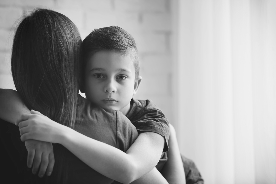 Sad Little Boy Hugging a Woman Copy Space 